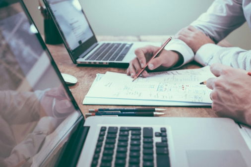 person-holding-pencil-near-laptop-computer.jpg person holding pencil near laptop computer